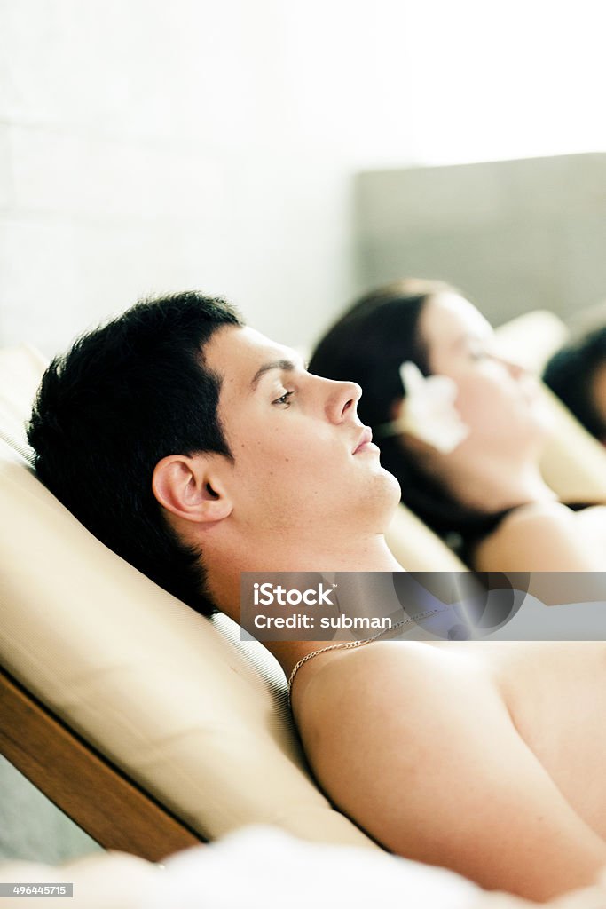 I'm Relaxed Group of young adults relaxing on loungers at a spa Adult Stock Photo