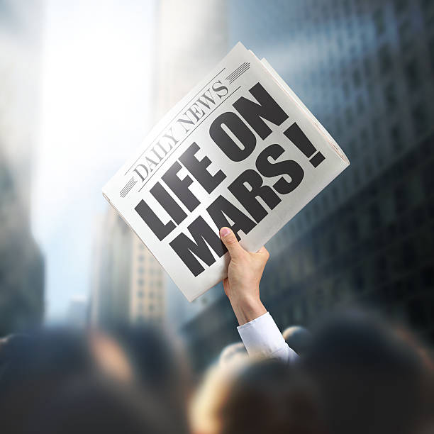 istock Holding Newspaper Life on Mars 496446197