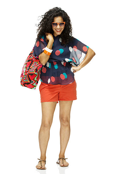 istock Cheerful woman standing and holding purse 496446527