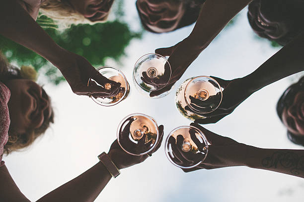 Woman toasting with sparkling wine and champagne Woman toasting with sparkling wine and champagne bachelorette party stock pictures, royalty-free photos & images