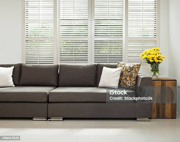 Grey Sofa In Simple Setting Stock Photo - Download Image Now - Shutter, Window Blinds, Wood - Material