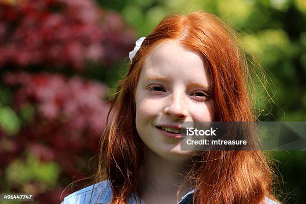 Pretty Happy Girl With Long Red Hair Smiling To Herself Stock Photo - Download Image Now