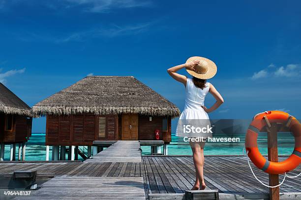 Woman On A Beach Jetty At Maldives Stock Photo - Download Image Now - Adult, Beach, Blue