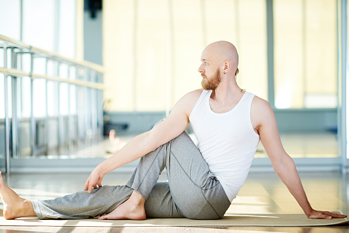 Yoga instructor doing Ardha Matsyendrasana - half spinal twist