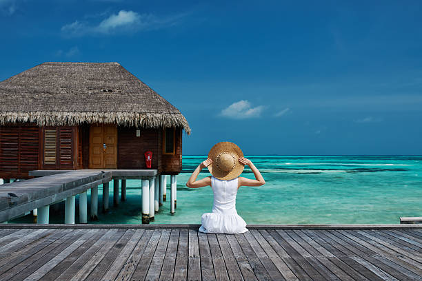 istock Woman on a beach jetty at Maldives 496450027