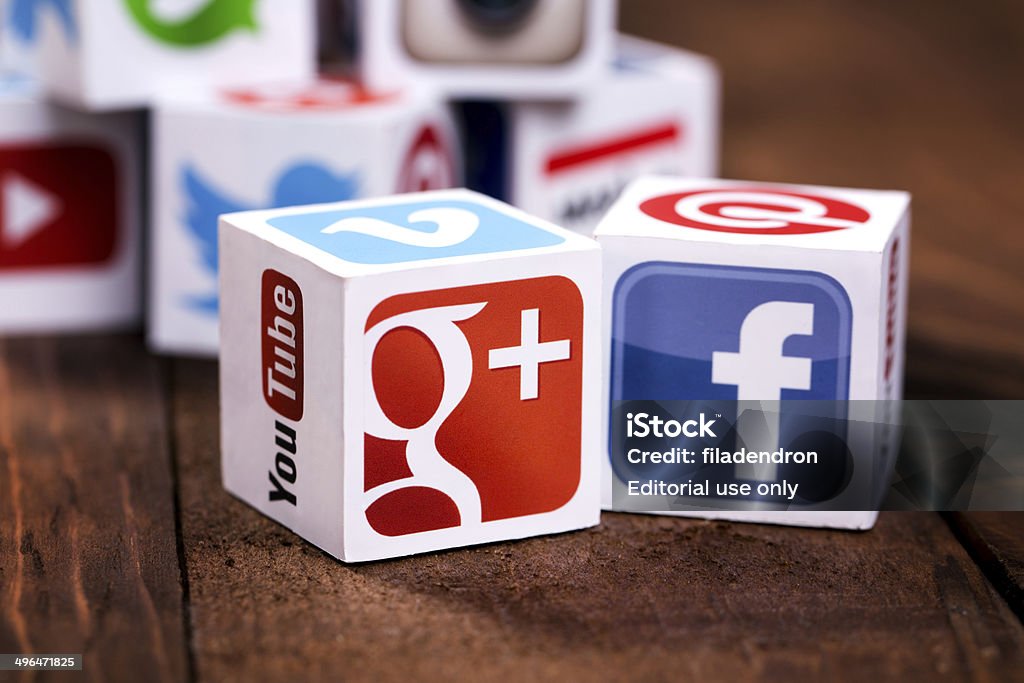 Social media cubes on a wooden background Sofia, Bulgaria - May 21, 2014: Social media logos printed onto handmade cubes. Logos include Facebook, instagram, linkedin, blogger. Social media uses web and mobile technology to connect people. Google - Brand-name Stock Photo