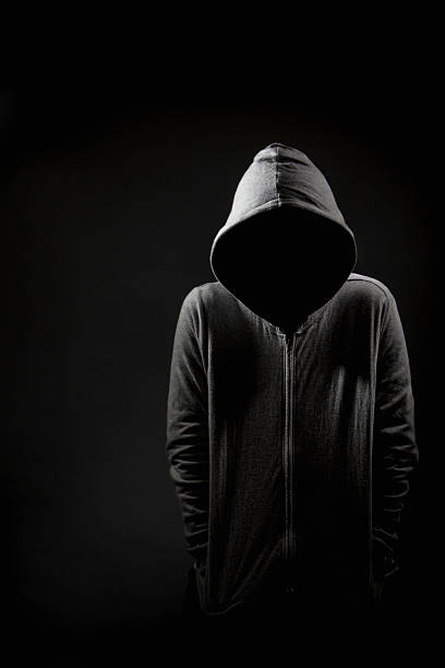 Lurking Villanous character in grey hoodie with copy space wrongdoer stock pictures, royalty-free photos & images