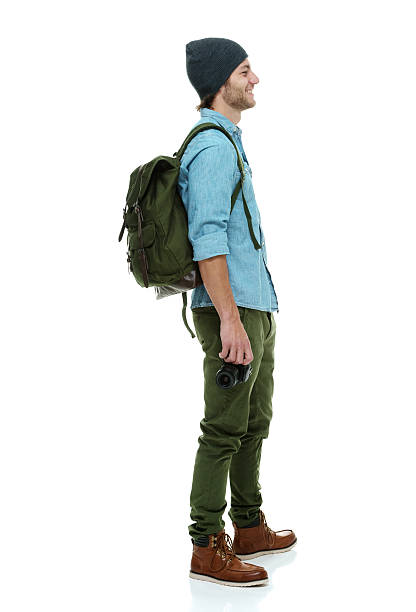 istock Side view of happy man standing with camera 496473109