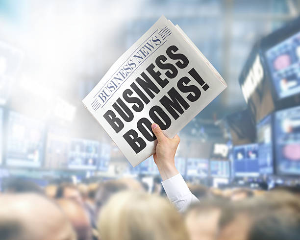 istock Holding Newspaper with Business Booms 496474805