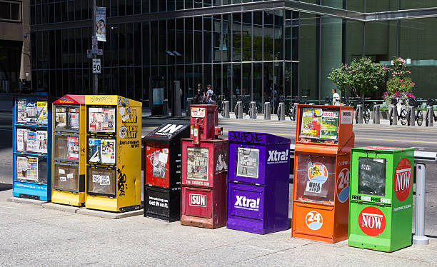 Toronto, Canada - June 1st, 2014: Various newspaper and magazine dispensers on a street in Toronto