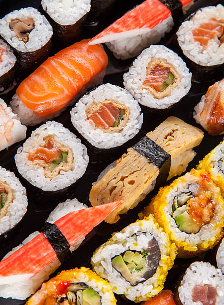 istock Delicious sushi pieces served on black stone 496476325