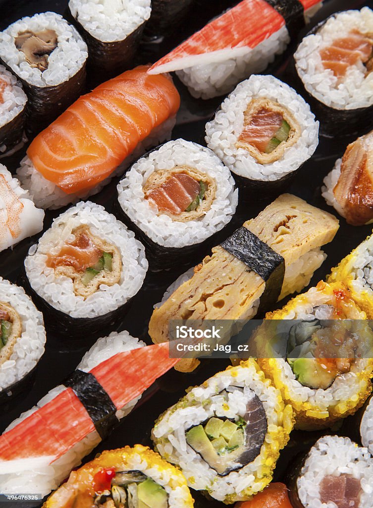 Delicious sushi pieces served on black stone Various kinds of sushi food served on black stone Asia Stock Photo