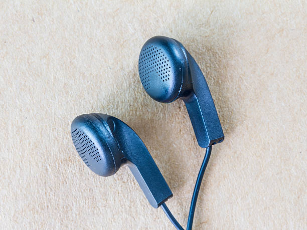 istock Earphones on wood background 496481522
