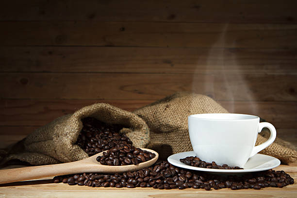 istock Coffee cup and coffee beans on wooden background. 496483426
