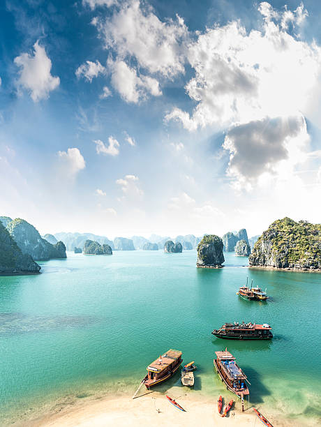 View Of Halong Bay In Vietnam A Beautiful View Of Tourist Boats In Halong Bay, Vietnam karst formation photos stock pictures, royalty-free photos & images
