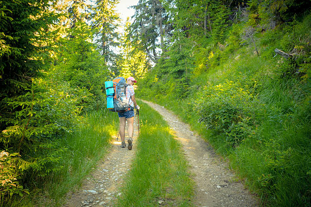 istock woman with a backpack on the trail 496484480