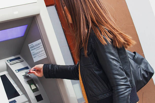 istock Young woman at the ATM machine 496485946