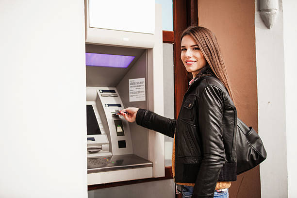 istock Young woman at the ATM machine 496486038