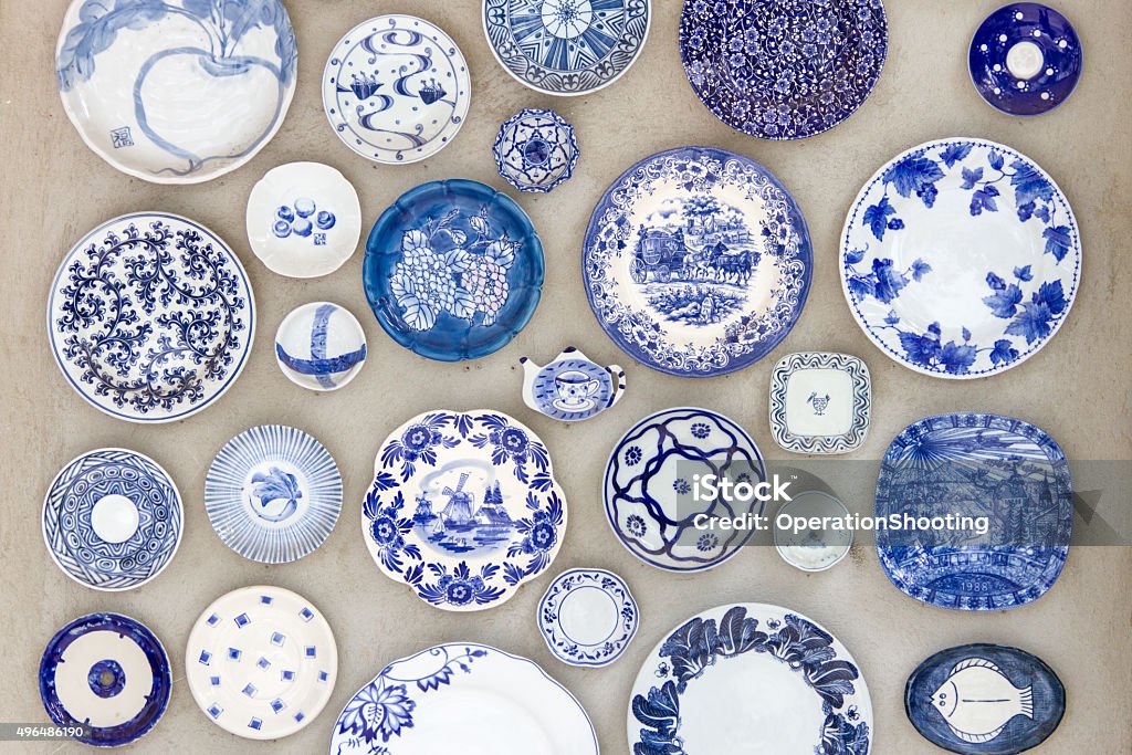Porcelain plates placed on the cement floor for background. Porcelain Stock Photo