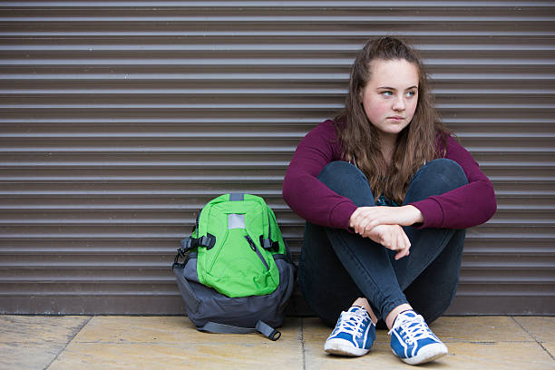 Homeless Teenage Girl On Streets With Rucksack Homeless Teenage Girl On Streets With Rucksack sad 15 years old girl stock pictures, royalty-free photos & images