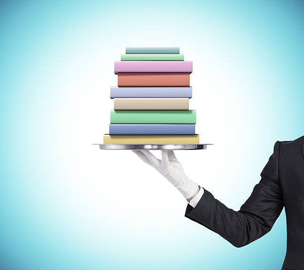 istock Man is keeping a tray with pack of books 496489506