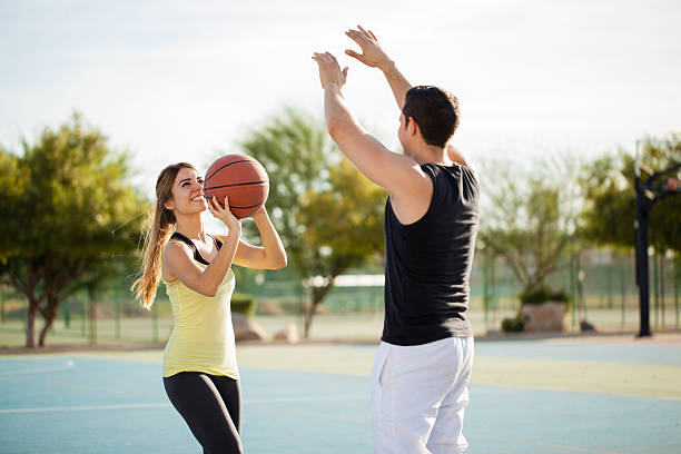 istock Pretty couple shooting some hoops 496490896