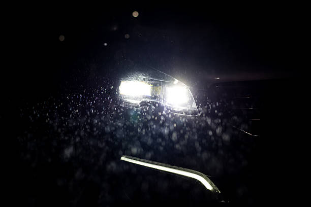istock Close-up on a car headlight. Night. Rain 496492230