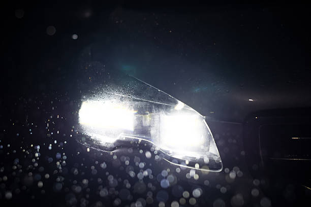 istock Close-up on a car headlight. Night. Rain 496492300