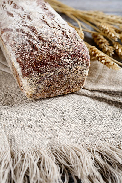 istock Loaf of Bread with wheat spikelets 496493012