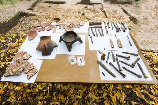 Human bones and pottery are shown on a table from archaeological excavions in Bulgaria.