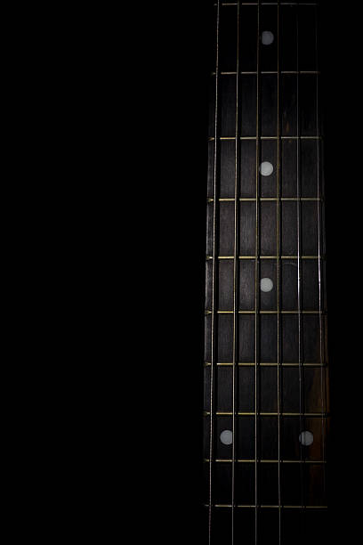 istock guitar neck isolated on black background 496494356
