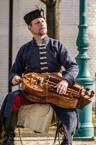 Budapest, Hungary - April 13, 2013: Hungarian man dressed in Traditional clothing playing a Wind-lute near Budapest Castle in Hungary.