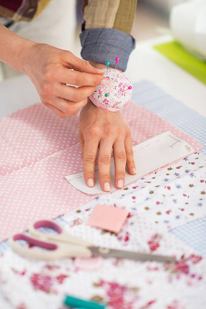 istock closeup on seamstress working with fabric 496514475