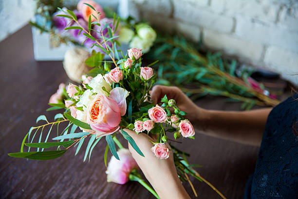 istock Florist at work. Woman making spring floral decorations 496514629