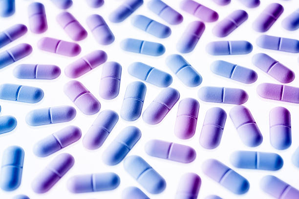 istock Pills in purple and blue light 496514761