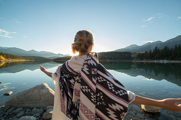 istock Cheering woman open arms to sunrise 496514850