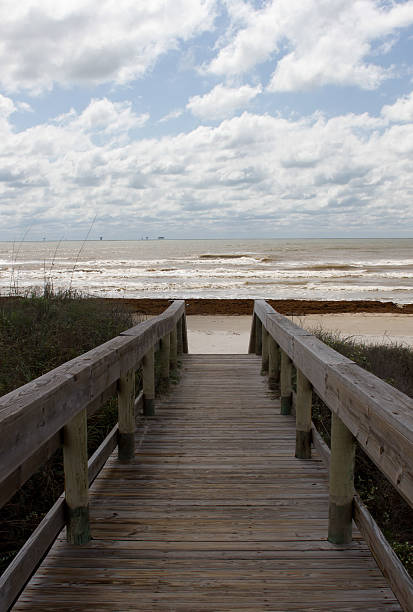 istock The boardwalk leading to the beach on a cloudy day 496516325