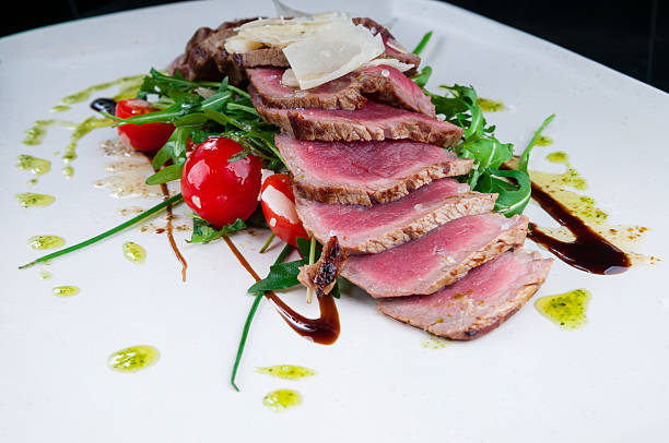 istock Medium rare steak served on a plate with vegetables 496516422