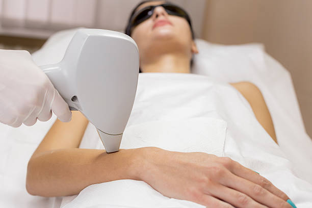 istock Laser hair removal on client hand in beauty salon 496516576