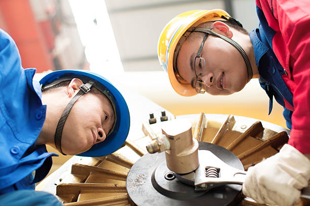 istock The workers are installing a machine in a factory 496517253