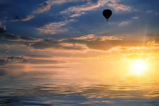 istock sky and air balloon reflected in water 496518798
