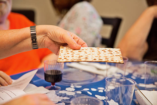 Participating in a traditional Passover seder Participating in a seder at a table set for a traditional Passover seder. RM jodijacobson stock pictures, royalty-free photos & images