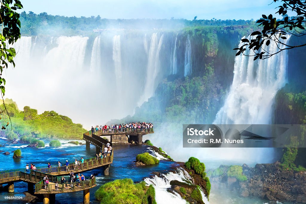 Iguazu Falls, on the border of Argentina and Brazil Tourists at Iguazu Falls, one of the world's great natural wonders, on the border of Brazil and Argentina. Iguacu Falls Stock Photo