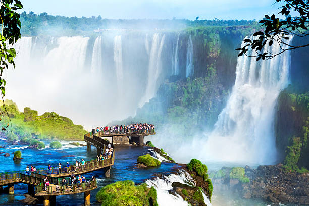 Iguazu Falls, on the border of Argentina and Brazil Tourists at Iguazu Falls, one of the world's great natural wonders, on the border of Brazil and Argentina. paraguay stock pictures, royalty-free photos & images