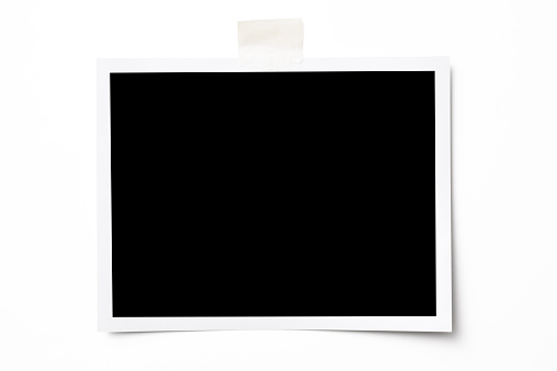 Close-up of blank photo with adhesive tape isolated on white background with clipping path.