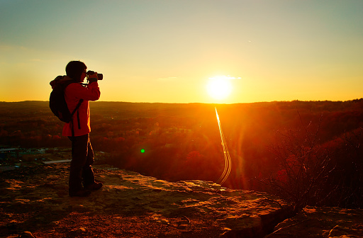 female traveler photographing  at sunrise