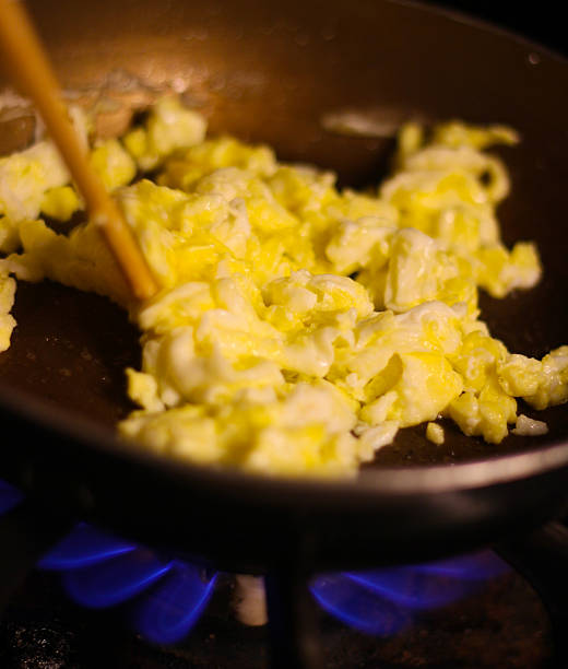istock Scrambled Eggs Cooking on Gas Stove - Stock Image 496541066