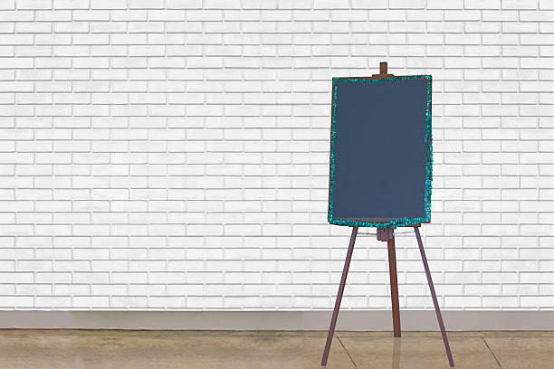istock blackboard Stand at the white brick wall 496541906