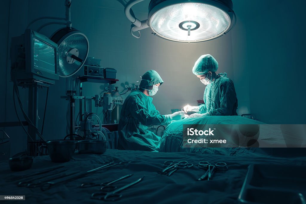 Surgeons team working Surgeons team working with Monitoring of patient in surgical operating room. Surgery Stock Photo