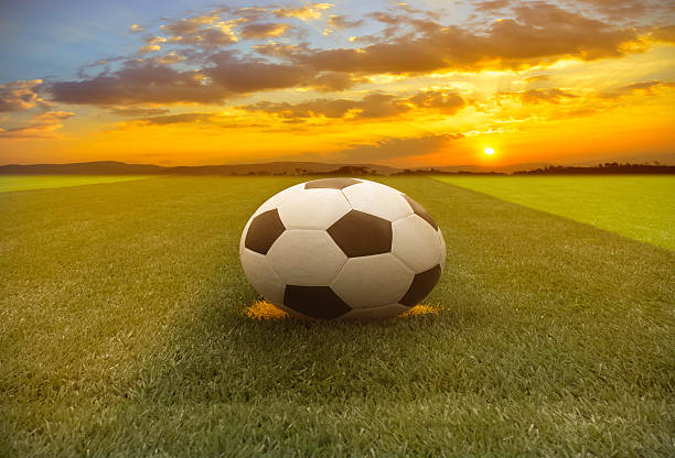 istock soccer ball on the field with sunset 496543544